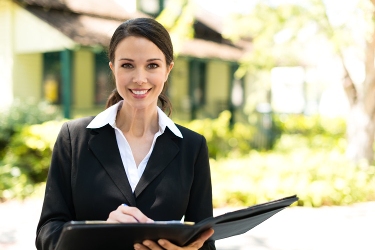 Real estate agent broker with bungalow house in background