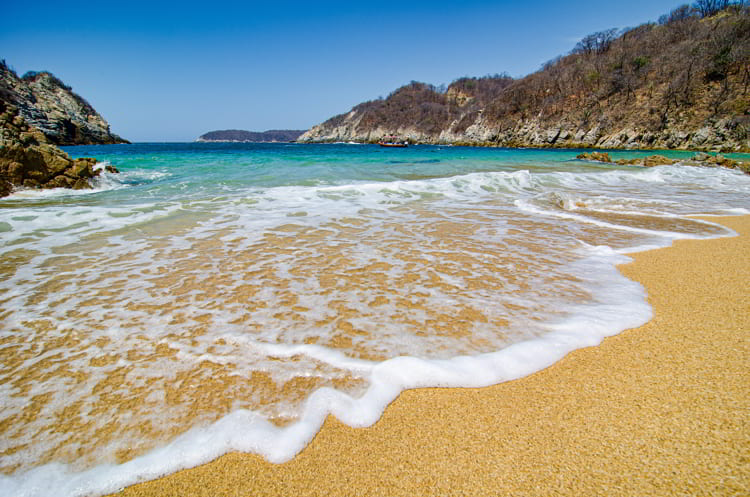 Paradise sand beach with turquoise blue water in Huatulco, Oaxaca, Mexico