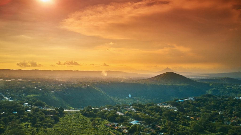 Nicaraguan Mountains. Sunsest over a mountain town as panoramic shows scattered houses and mountain ranges in the distance