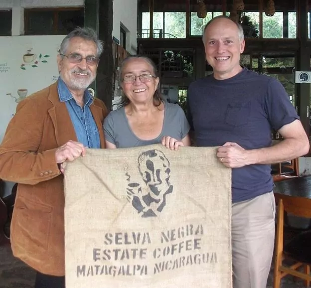 Mike Cobb with the owners of Selva Negra Coffee Estate. They are posing with one of their sacks which is used to store the coffee beans in.