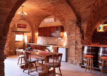 Vaulted ceilings with exposed bricks in an Italian cantina, in Abruzzo. Kitchen area.