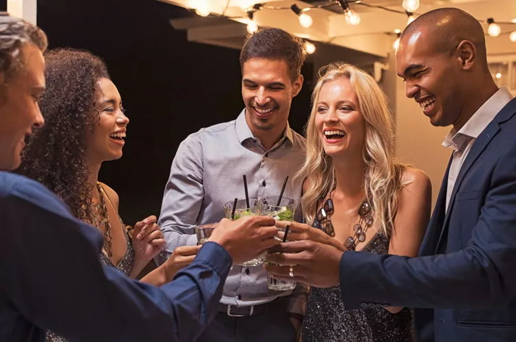 people laughing at a cocktail party