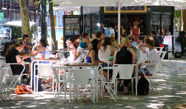 People sit outside a cafe in Avenida da Liberdade, Lisbon