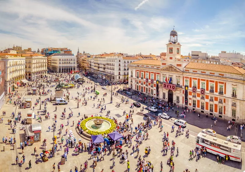 A tourist town in Europe with lots of people outside the square