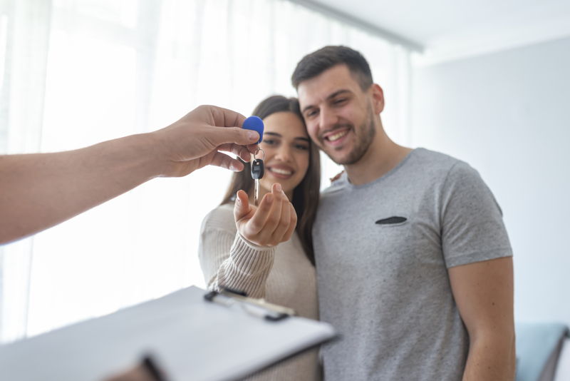 A property manager handing house keys over to new tennants