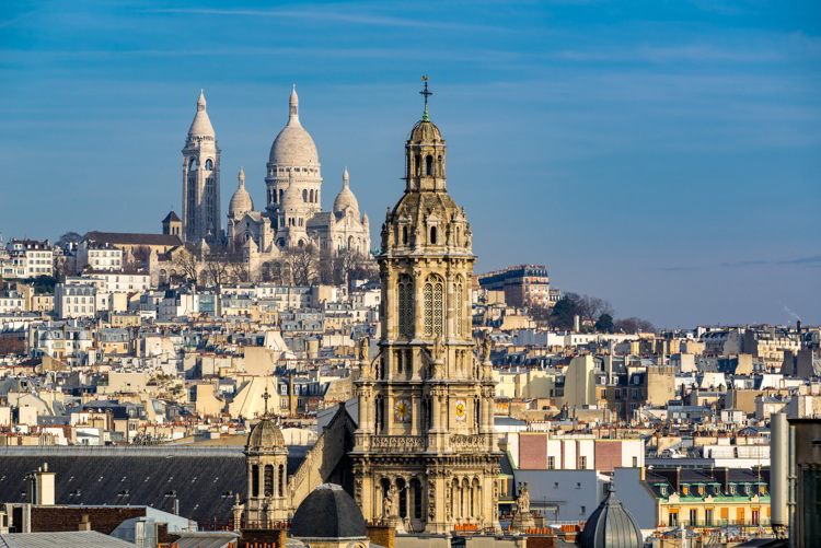 Rooftops of Paris with view of the Sacre Coeur Basilica in Montmartre and the Trinity Church