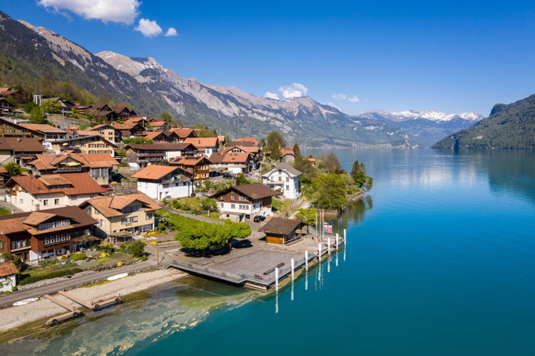 Idyllic Oberried village by the alpine lake Brienz in Bern, Switzerland on a sunny day.