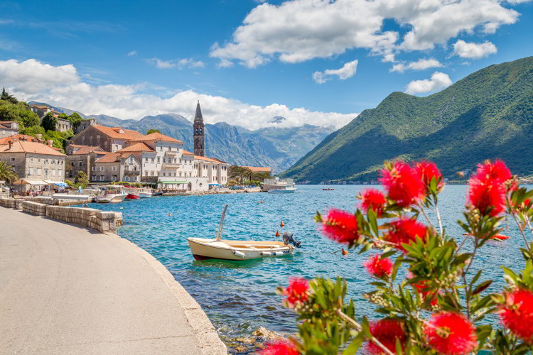 Historic town of Perast located at world-famous Bay of Kotor on a beautiful sunny day with blue sky and clouds in summer, Montenegro.