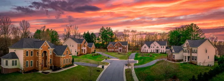 Neighborhood street sunset panorama of modern upper middle class single family houses