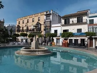 Houses and a fountain in Chiclana de la Frontera, Spain