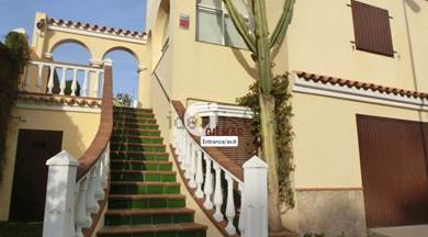 A house with an outside staircase in Sanlúcar, Spain