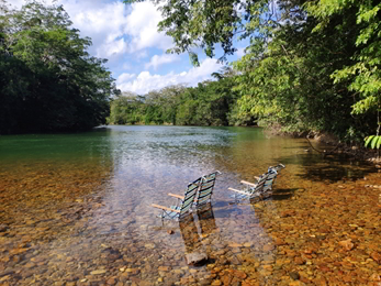 Chairs on a lake with crystal clear water in Belize