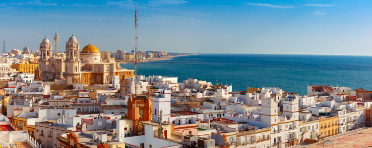 Aerial panoramic view of the old city rooftops and Cathedral de Santa Cruz in the morning from tower Tavira in Cadiz, Andalusia, Spain