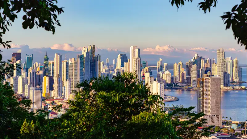 View of the skyline of Panama City framed by tropical rain forest