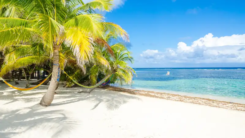 Relaxing on chair - Belize Cayes - Small tropical island at Barrier Reef with paradise beach - known for diving, snorkeling and relaxing vacations