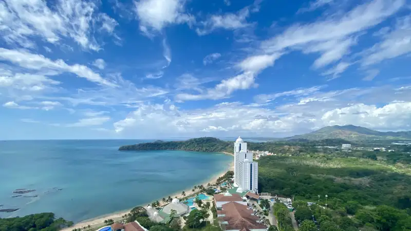 Aerial view of a beachfront resort and coastline in Panama under a bright blue sky.