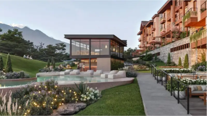 A modern luxury resort with landscaped gardens, a serene pool lounge, and mountain views, offering an elegant retreat in a scenic hillside setting.