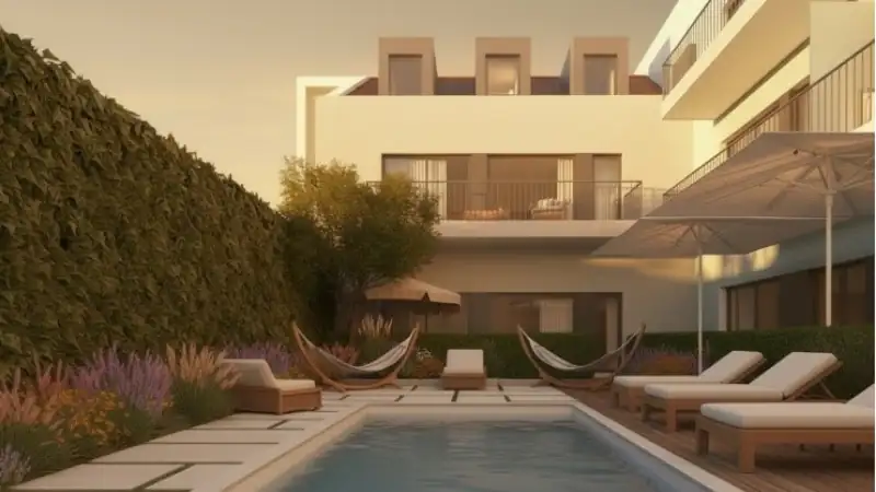 A contemporary apartment courtyard featuring a swimming pool, lounge chairs, hammocks, and landscaped gardens at sunset.