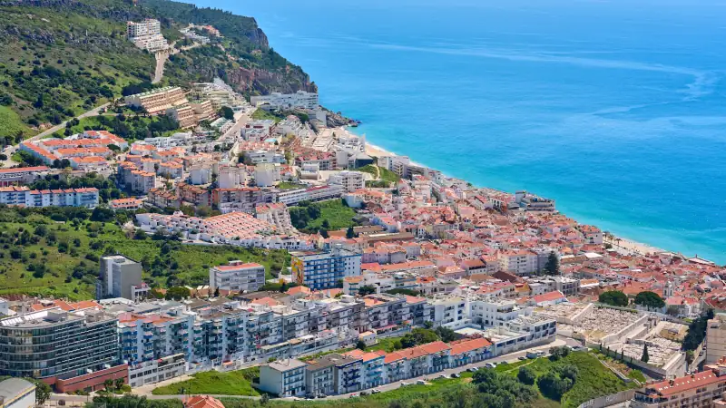 aerial view over city of Sesimbra with atlantic ocean in background